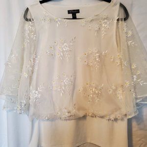 Ladies white sheer top with daises.